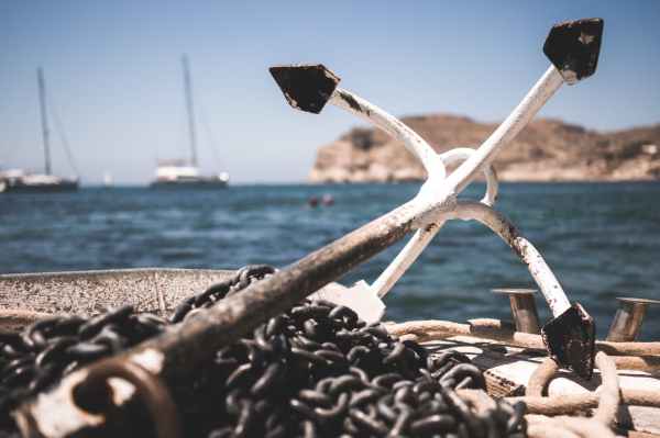 white and black anchor with chain at daytime